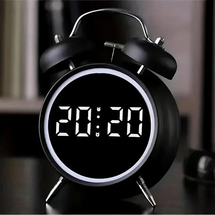 Modern black digital alarm clock with LED display showing 20:20 on a desk