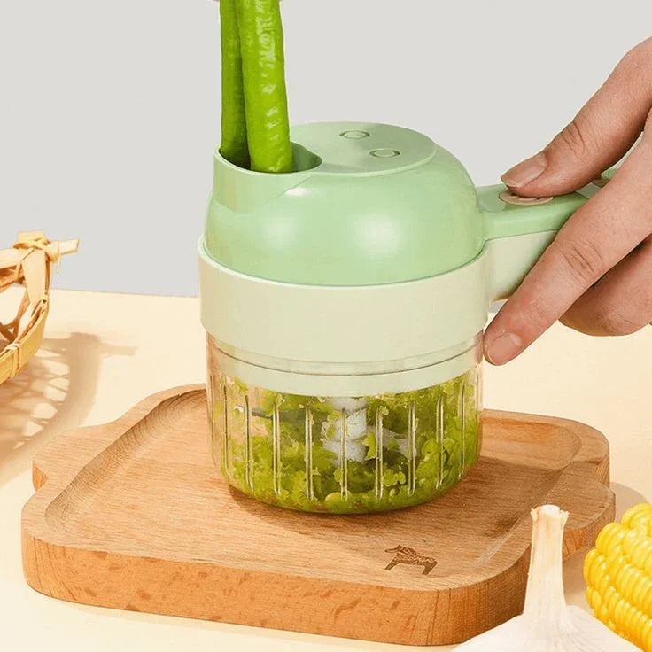 Electric vegetable chopper slicing green peppers on a wooden tray in a kitchen setting
