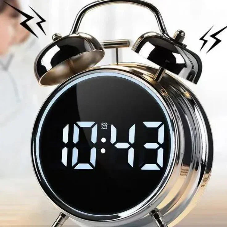 Modern digital alarm clock with LED display and twin bell design showing 10:43 AM