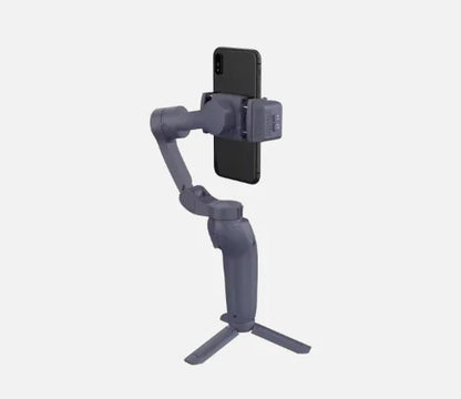 Portable smartphone gimbal stabilizer with tripod, gray, holding a black smartphone
